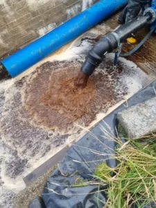 dirty water exiting pipe - pigging system - proterra energy renewables asset management